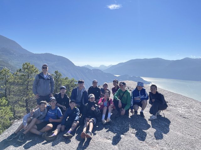 Reaching the summit together on a group hike
