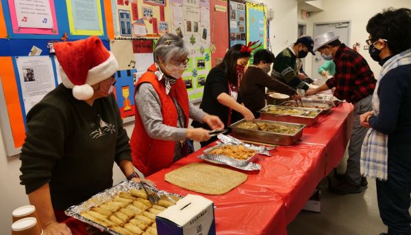 Faith Fellowship members serving lunch at a Caleb Fellowship gathering
